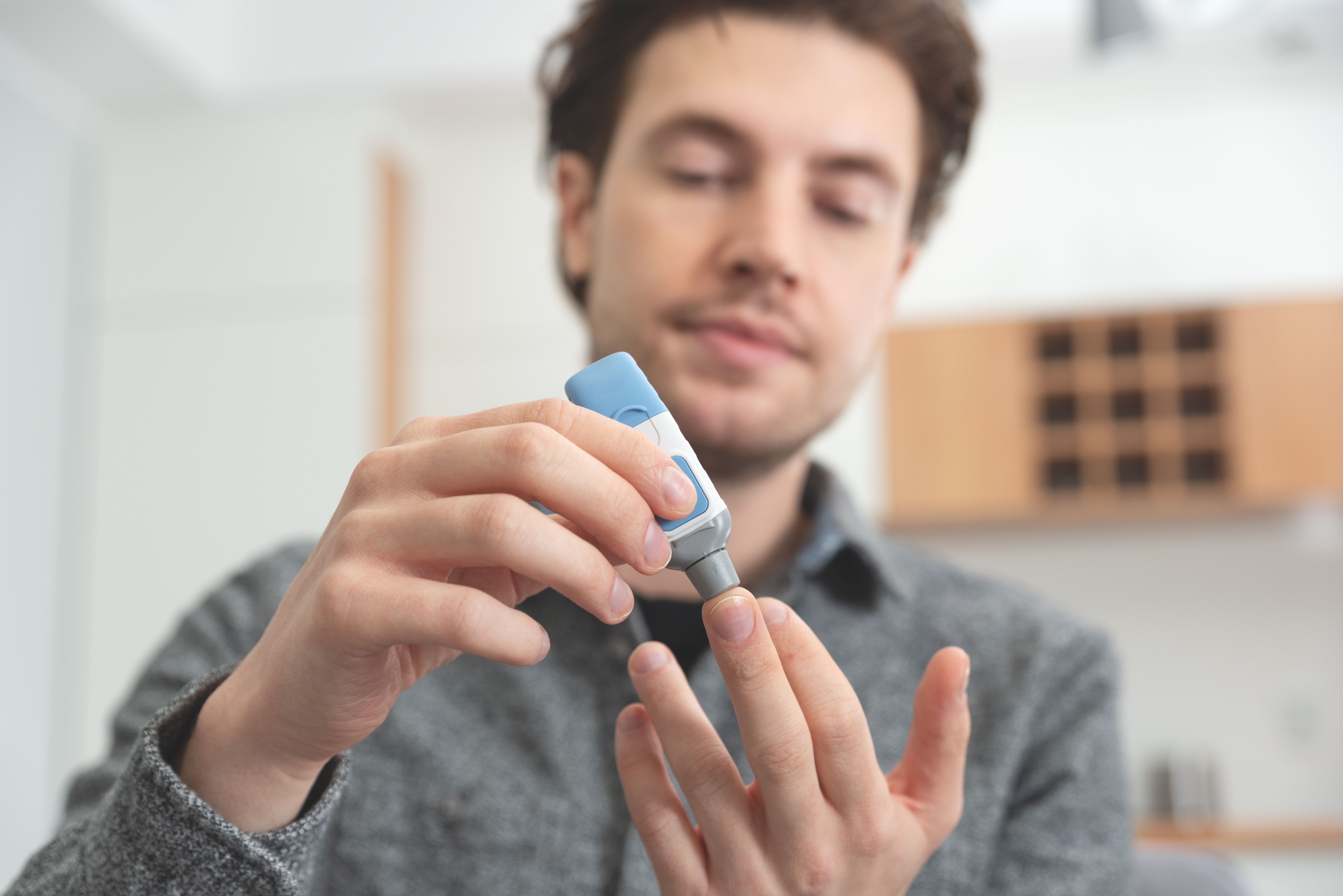 Young Man Measures Blood Level.