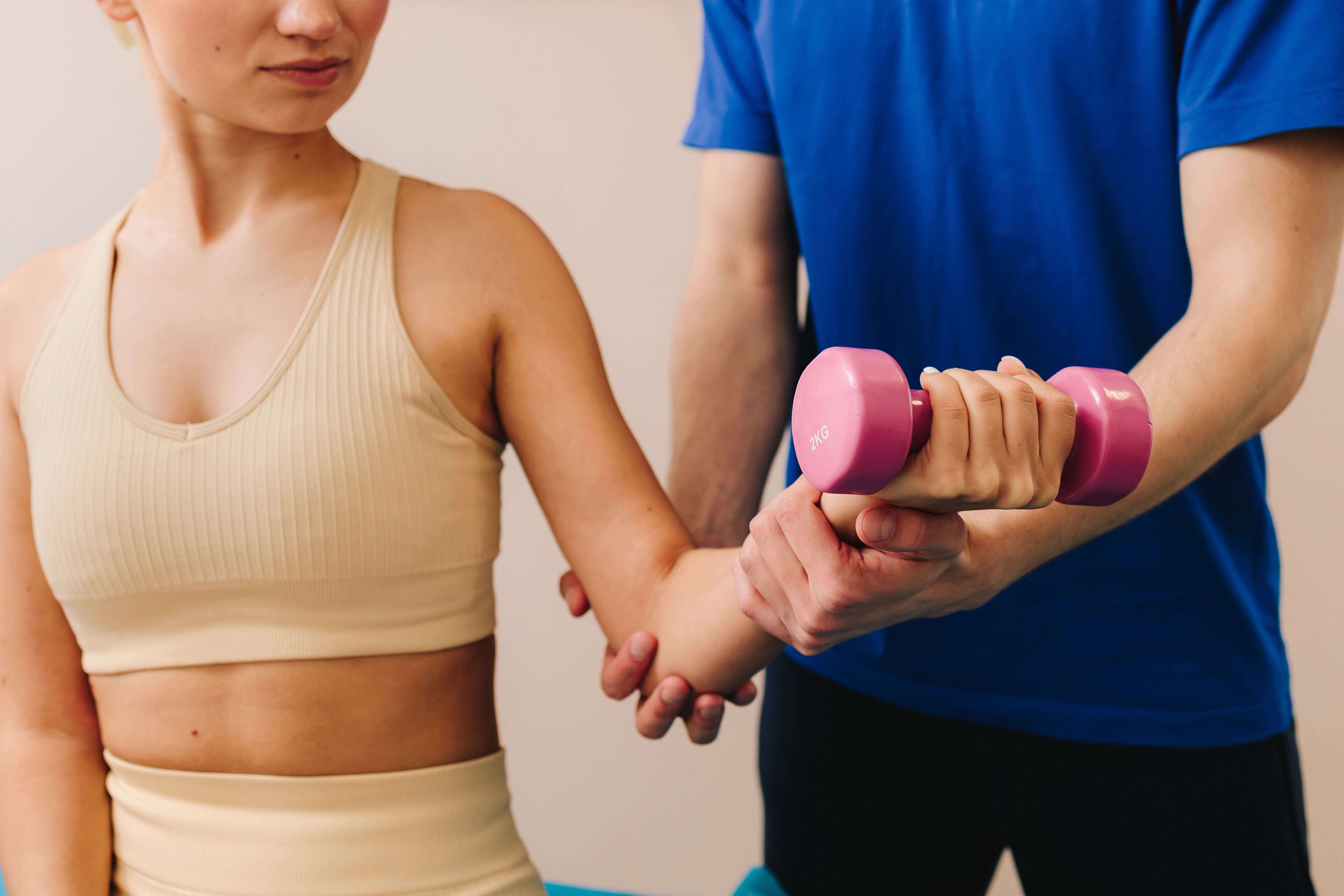 Therapist Is Helping Patient To Restore Arm Movement After Illness. Doctor Is Helping With Physiotherapy To Restore Body Functioning. Effective Pt To Heal From Injury. Therapist Is Helping Patient To Restore Arm Movement After Illness. Doctor Is Helping With Physiotherapy To Restore Body Functioning. Effective Pt To Heal From Injury.